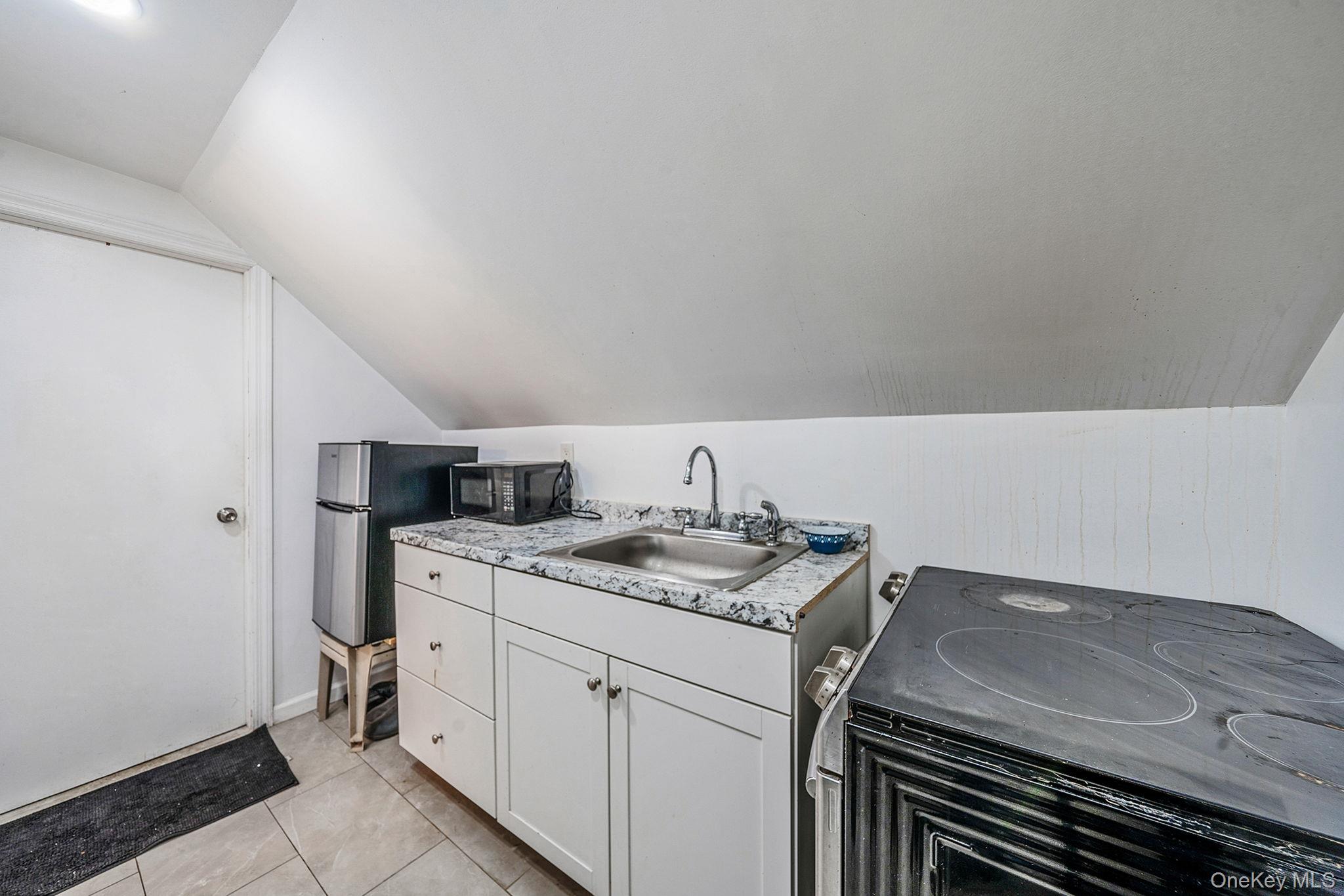 98 Miriam Street Valley Stream, NY 11581 - Photo 16 of 16 a utility room with sink dryer and washer