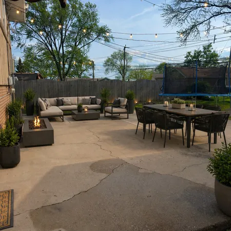 a view of a couches in patio and a fire pit