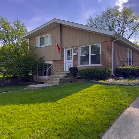 a front view of a house with a garden and patio
