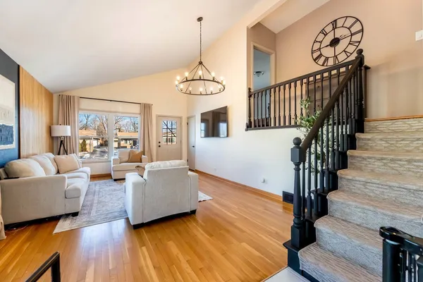 a living room with fireplace furniture and a wooden floor