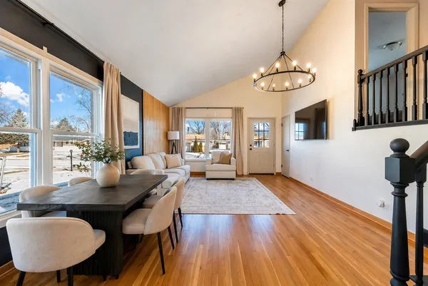 a view of a dining room with furniture wooden floor and chandelier