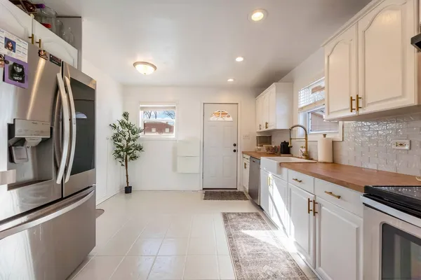 a kitchen with stainless steel appliances a refrigerator sink and cabinets