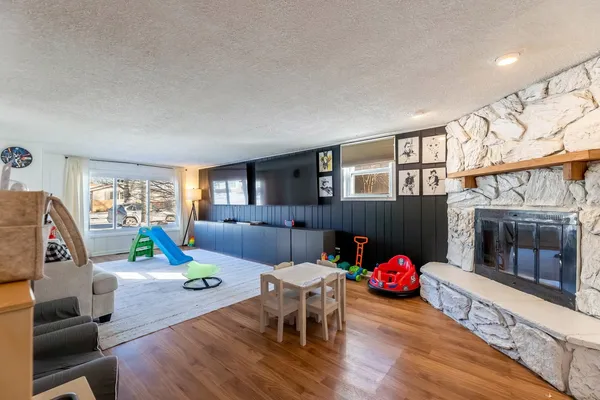 a living room with furniture and a wooden floor