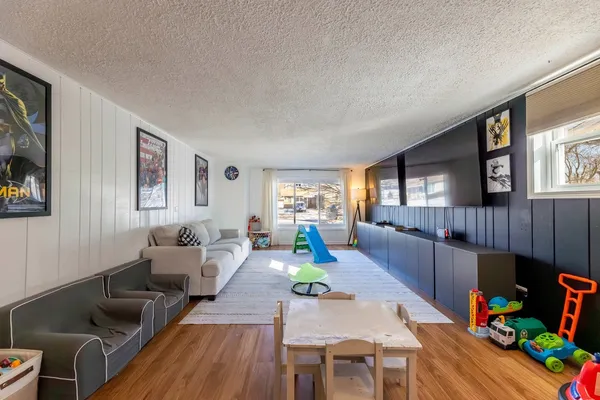 a living room with furniture fireplace and a window