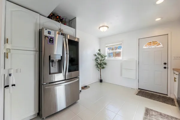 a metallic refrigerator freezer sitting in a kitchen