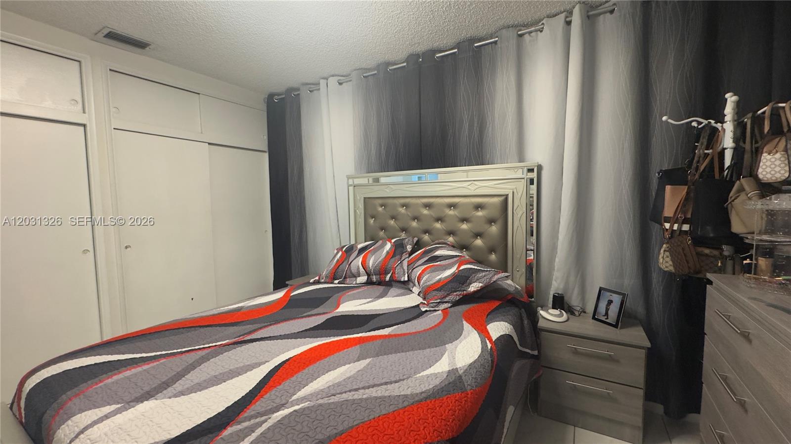 12480 Southwest 189th Street Miami, FL 33177 - Photo 11 of 25 a bedroom with a bed and a mirror