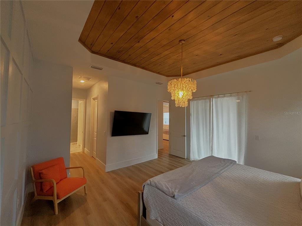 17435 Jadestone Court Venice, FL 34293 - Photo 12 of 68 a bedroom with a bed and a flat screen tv