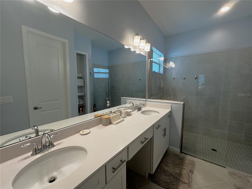 17435 Jadestone Court Venice, FL 34293 - Photo 14 of 68 a bathroom with a sink double vanity and a mirror