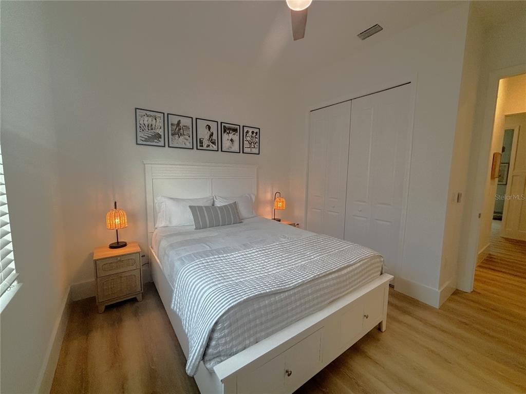 17435 Jadestone Court Venice, FL 34293 - Photo 16 of 68 a bedroom with a bed and wooden floor