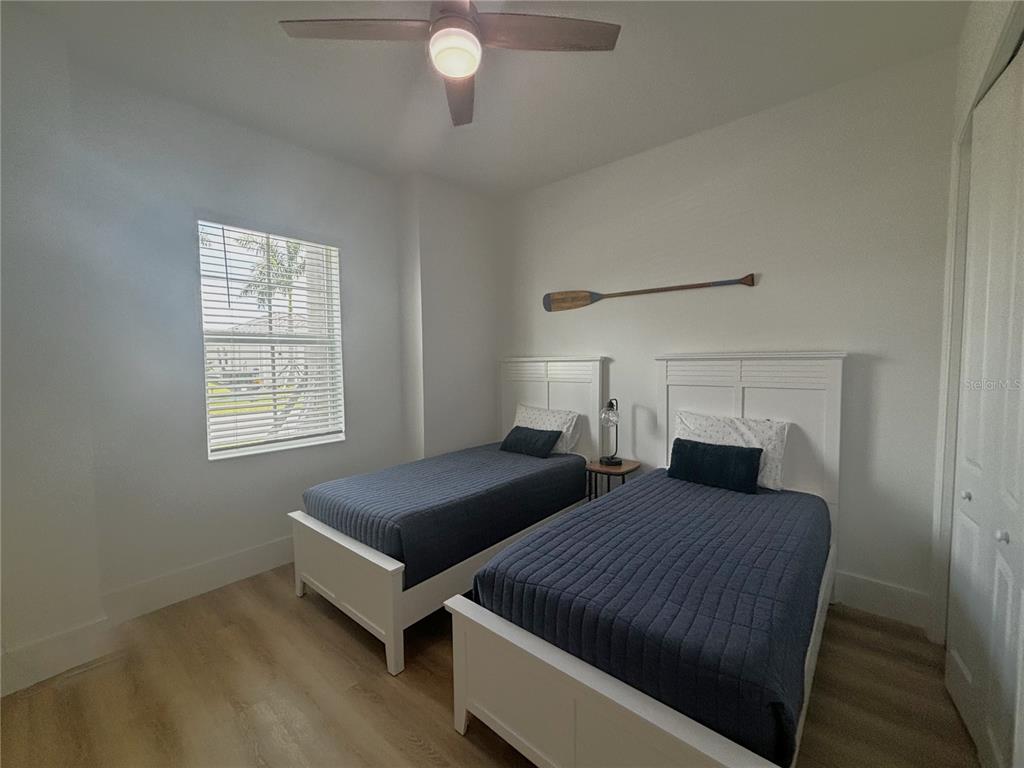 17435 Jadestone Court Venice, FL 34293 - Photo 19 of 68 a bedroom with two beds and a window