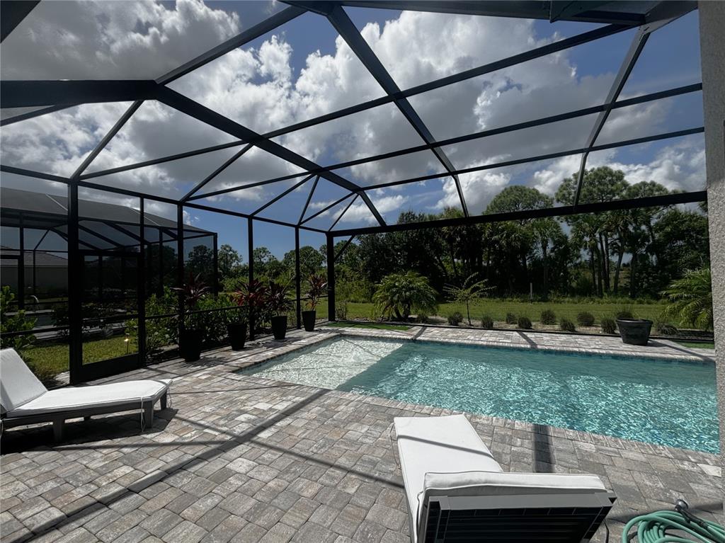 17435 Jadestone Court Venice, FL 34293 - Photo 26 of 68 a view of a patio with table and chairs barbeque grill with wooden fence
