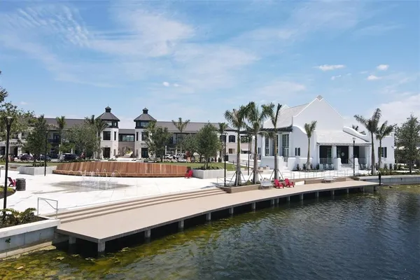 a view of a swimming pool with lawn chairs and a big yard