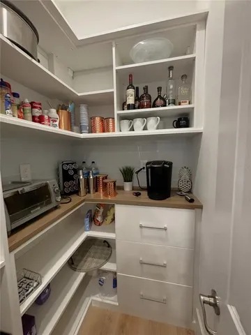 a kitchen with a cabinets and wooden floor