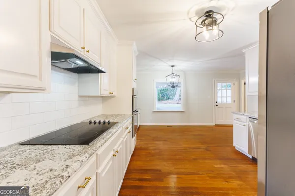 a kitchen with a sink a stove and cabinets