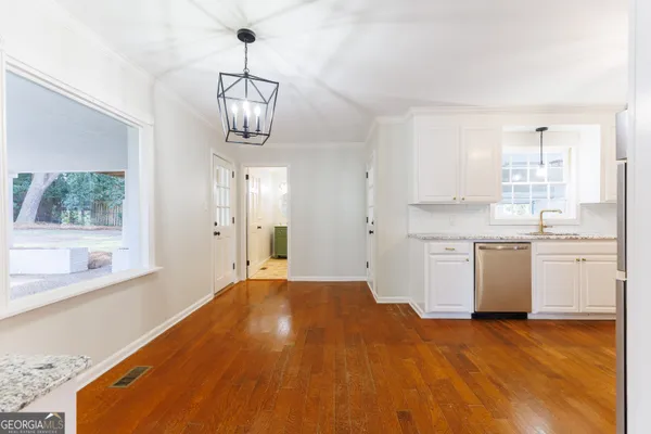 a kitchen with a stove a sink and a window