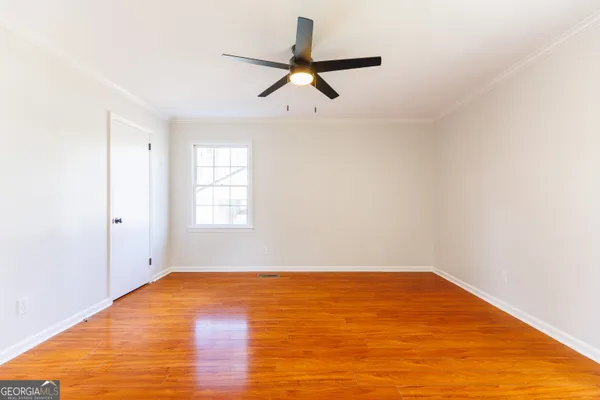 a view of empty room with wooden floor