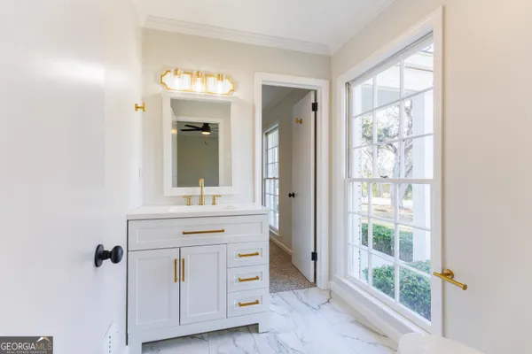 a bathroom with a sink a mirror and a window
