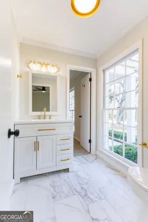 a bathroom with a sink a vanity and a mirror