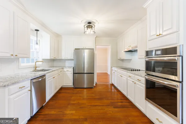 a kitchen with a refrigerator stove and sink