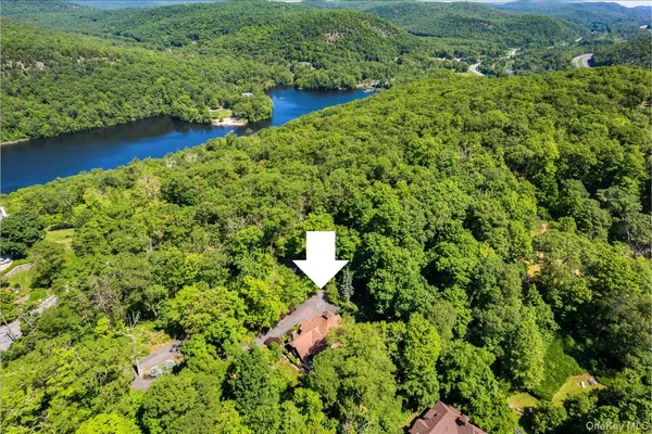 an aerial view of residential house with outdoor space and trees around