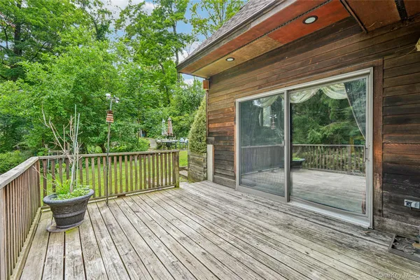 a view of balcony with wooden floor and fence