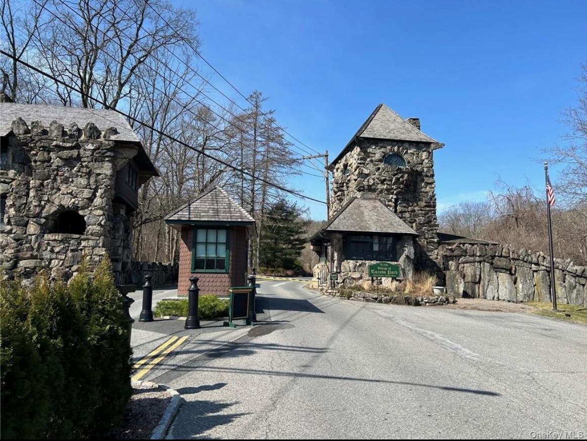 1 Lookout Road Tuxedo Park, NY 10987 - Photo 39 of 40 a patio with table and chairs with wooden fence