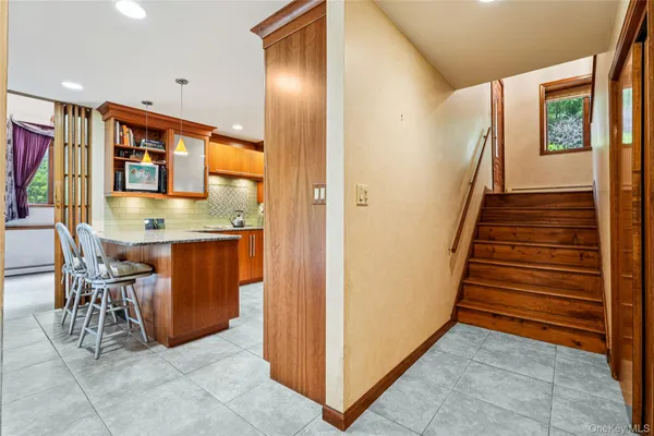 a view of kitchen with stainless steel appliances granite countertop lots of cabinets