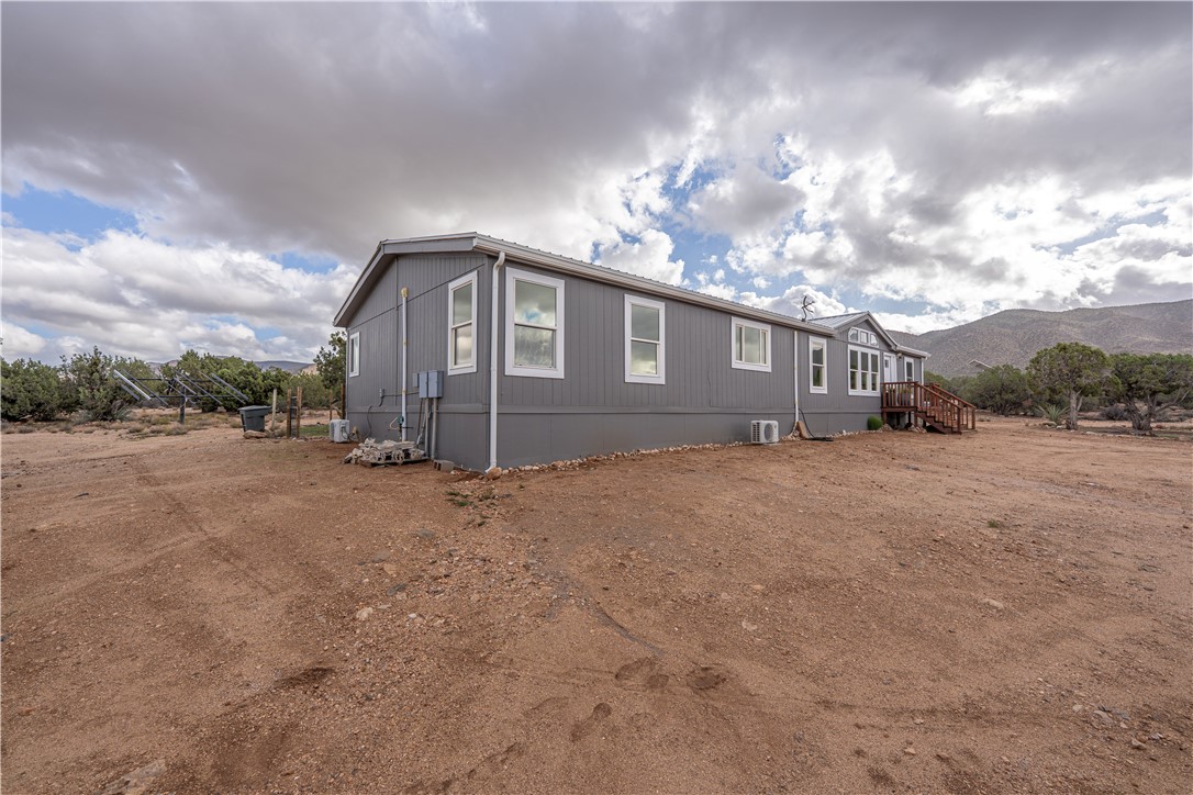 2765 North Silver Springs Road Kingman, AZ 86401 - Photo 9 of 60 a front view of a house with a yard and garage