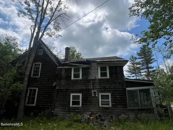 a front view of a house with plants