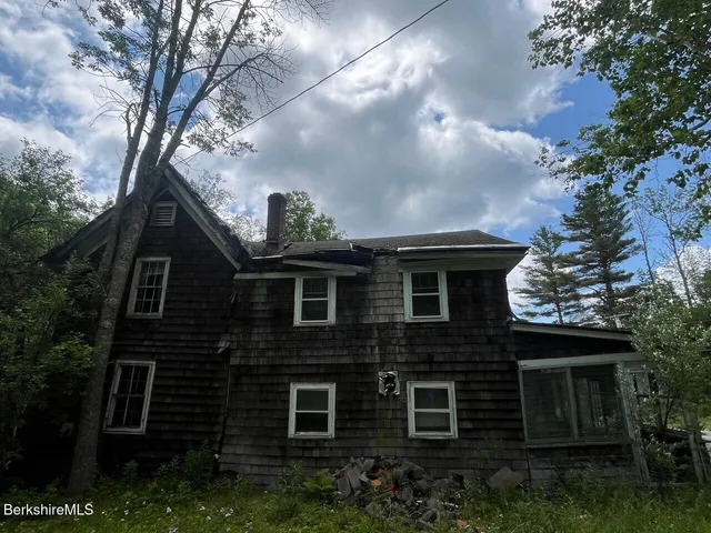 a front view of a house with plants