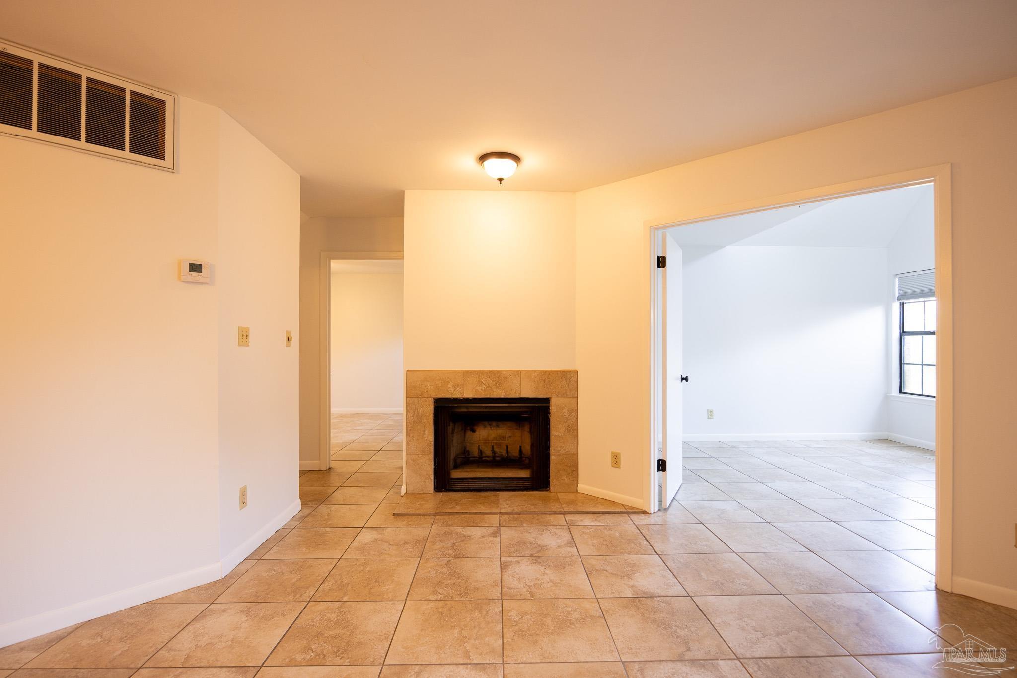 7150 Plantation Road, Unit 312 Pensacola, FL 32504 - Photo 3 of 14 a view of an empty room and fire place