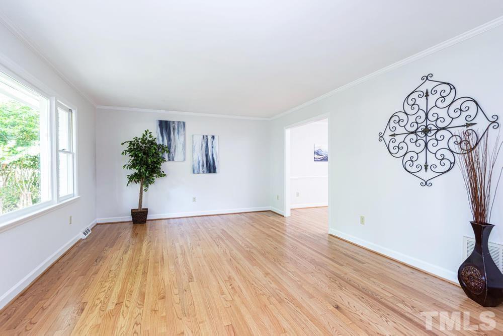 509 Compton Road Raleigh, NC 27609 - Photo 3 of 30 Family Room with hardwood floors, crown molding, and large front window.