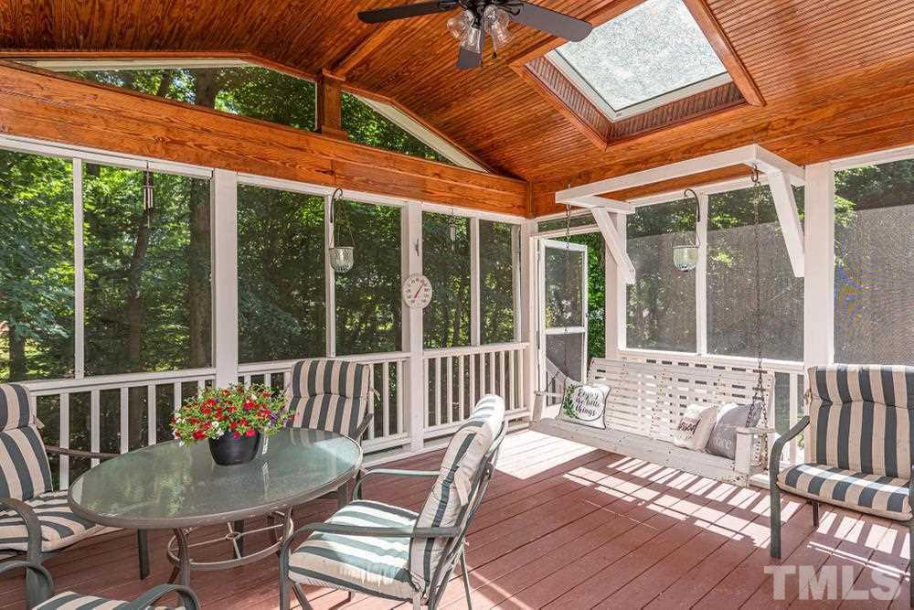 509 Compton Road Raleigh, NC 27609 - Photo 23 of 30 Beautiful screened porch with wooden ceiling, ceiling fan, porch swing, and skylights.