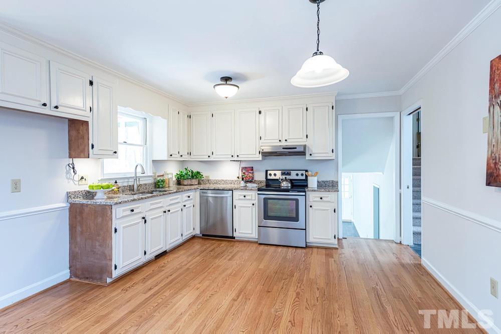 509 Compton Road Raleigh, NC 27609 - Photo 7 of 30 Kitchen features SS appls, hardwood floors, and access to screened porch.