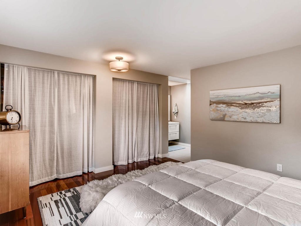 22108 1st Place West Bothell, WA 98021 - Photo 14 of 25 a bedroom with a bed and a chandelier