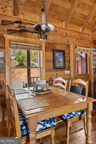 a view of a dining room with furniture a chandelier and wooden floor