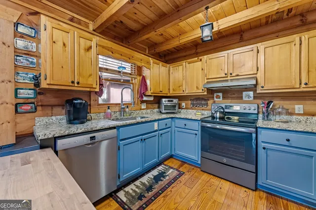 a kitchen with granite countertop cabinets stainless steel appliances a sink and a counter top