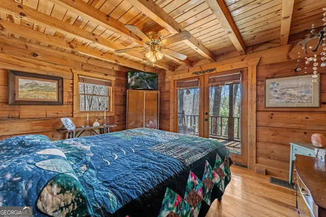 a bed sitting in a bedroom next to a window