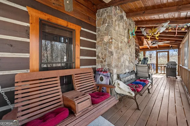 a view of a wooden chairs and fire pit in the backyard