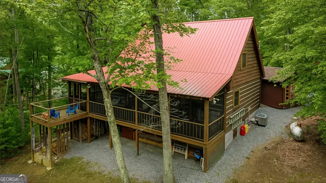a view of a chairs and table in the backyard