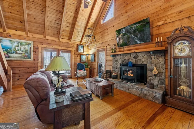 a living room with furniture a fireplace a rug and a window