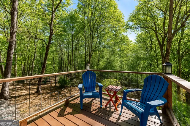a view of a balcony with wooden floor and outdoor seating