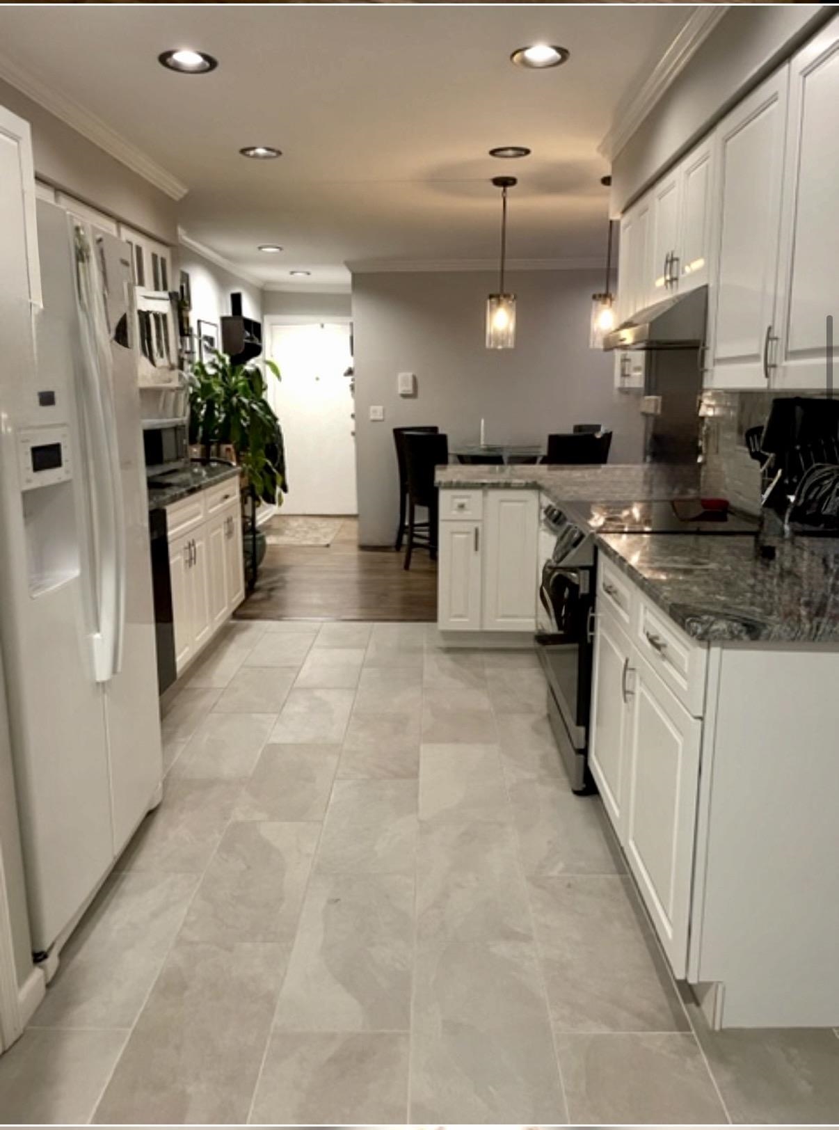 533 Madison Street, Unit 3A Hoboken, NJ 07030 - Photo 2 of 11 a kitchen with a refrigerator a sink and cabinets