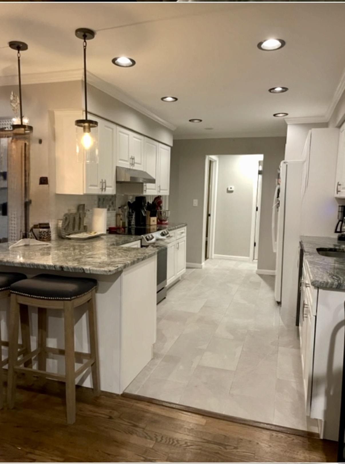 533 Madison Street, Unit 3A Hoboken, NJ 07030 - Photo 3 of 11 a kitchen with kitchen island granite countertop a sink appliances and cabinets