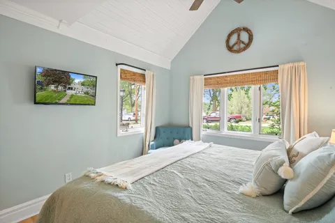 a bedroom with a bed and a large window
