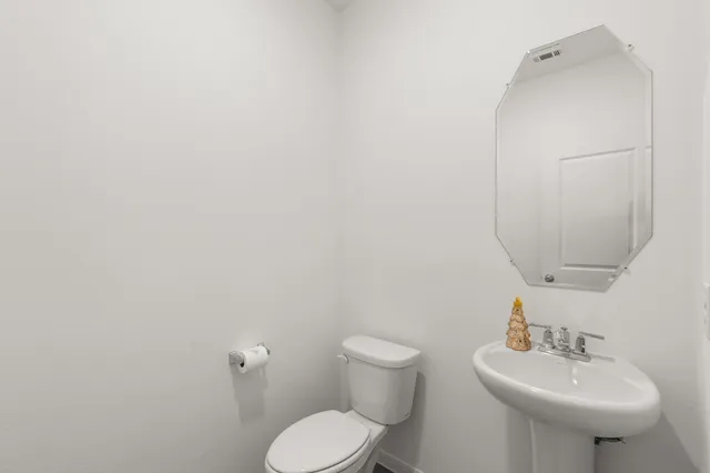 a bathroom with a sink toilet and mirror
