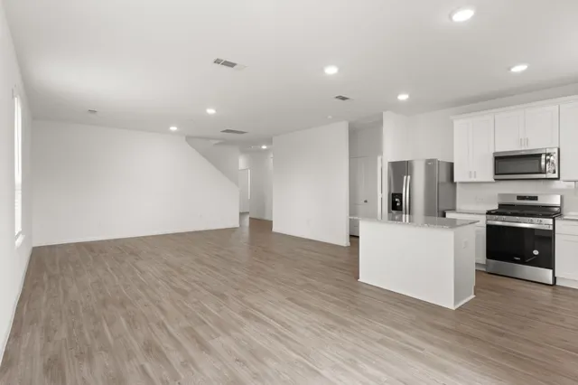 a view of kitchen with microwave and refrigerator
