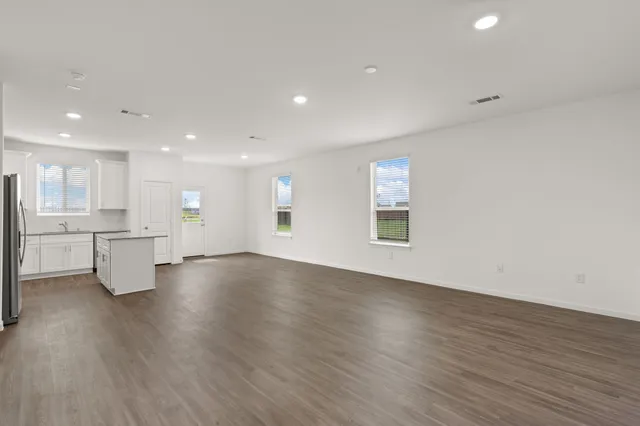 a view of kitchen with wooden floor and windows