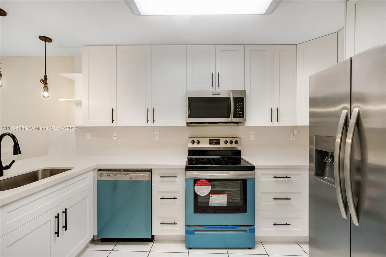 14364 Southwest 159th Terrace Miami, FL 33177 - Photo 11 of 32 a kitchen with stainless steel appliances a refrigerator stove and microwave