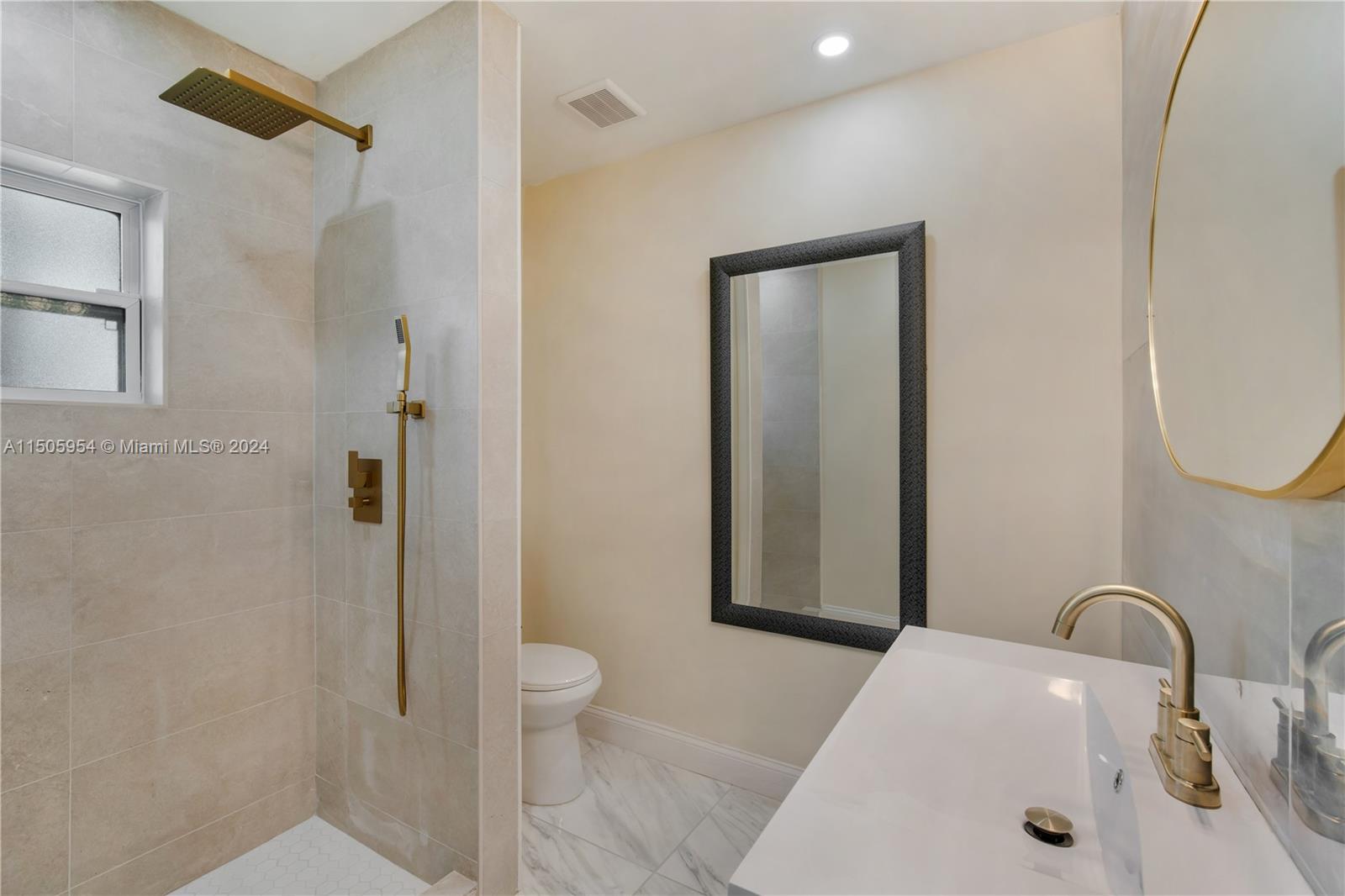 14364 Southwest 159th Terrace Miami, FL 33177 - Photo 24 of 32 a bathroom with a sink a toilet and shower